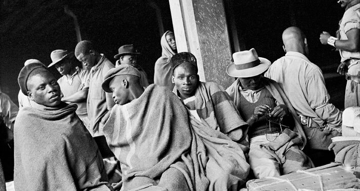 David Goldblatt Migrant mineworkers who had served their contracts on the gold mines and were waiting for a train to take them part-way to their homes in Nyassaland, (Malawi), Mayfair railway station. December 1952, January 2009
