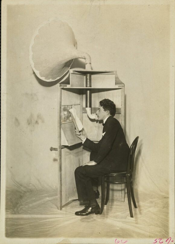 ISABEY STUDIO, Jean Cocteau at a phonograph pavilion on the set of his ballet Les Mariés de la Tour Eiffel, 1921, Vanity Fair © Condé Nast